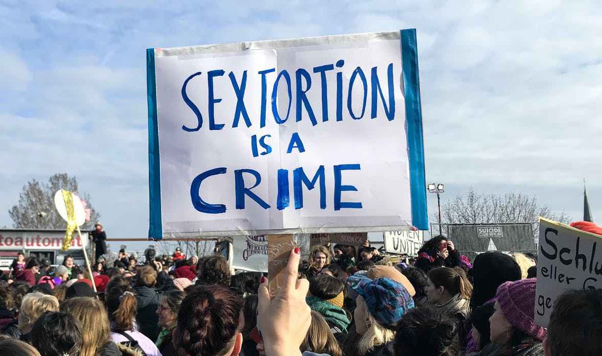 Banner at a march saying: "Sextortion is a crime"